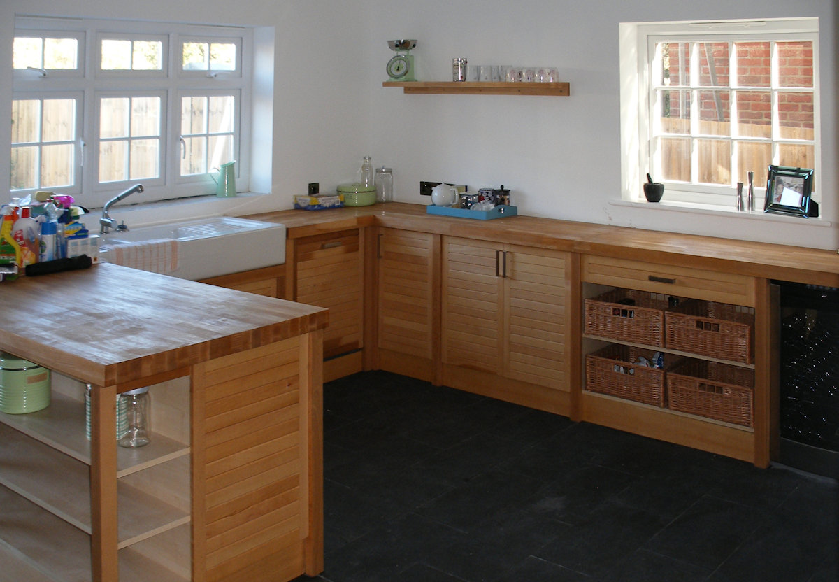 A spacious kitchen with access to the side garden becomes a social as well as functional cooking space