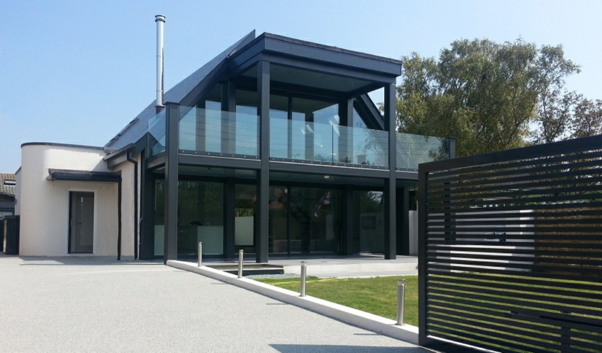 Contemporary house with split roof and framed balcony